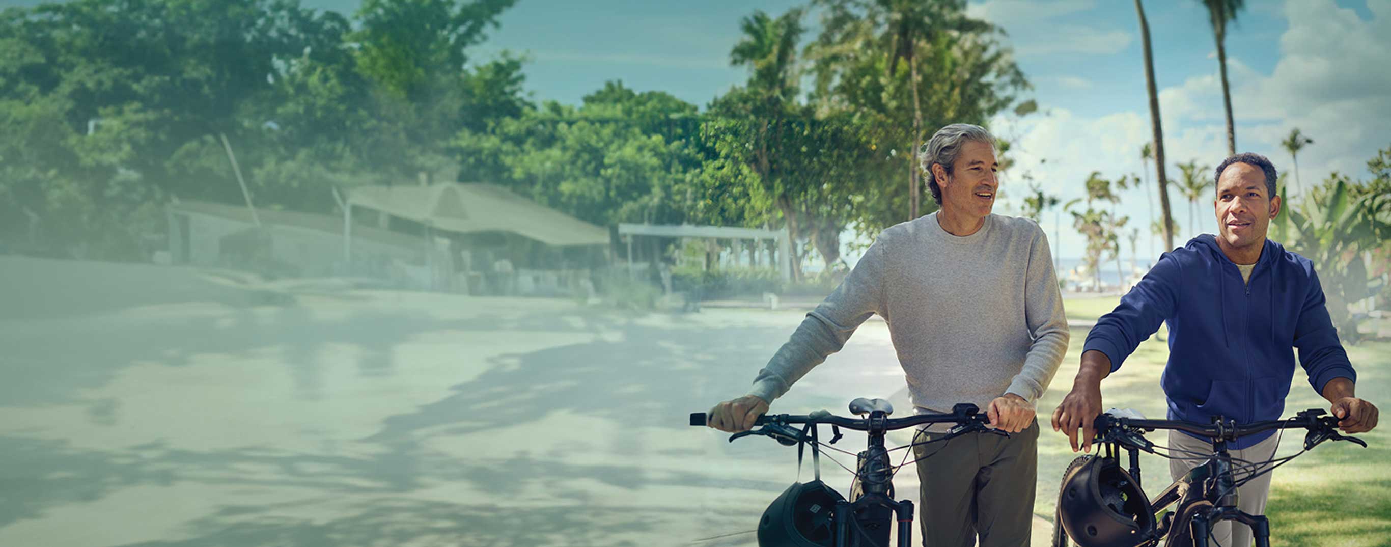 men walking with their bicycles