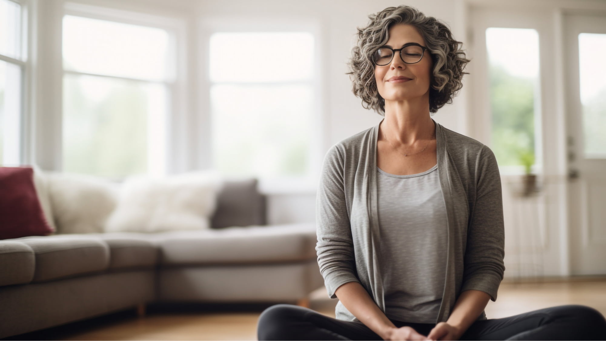 A middle-aged woman seated on the living room floor