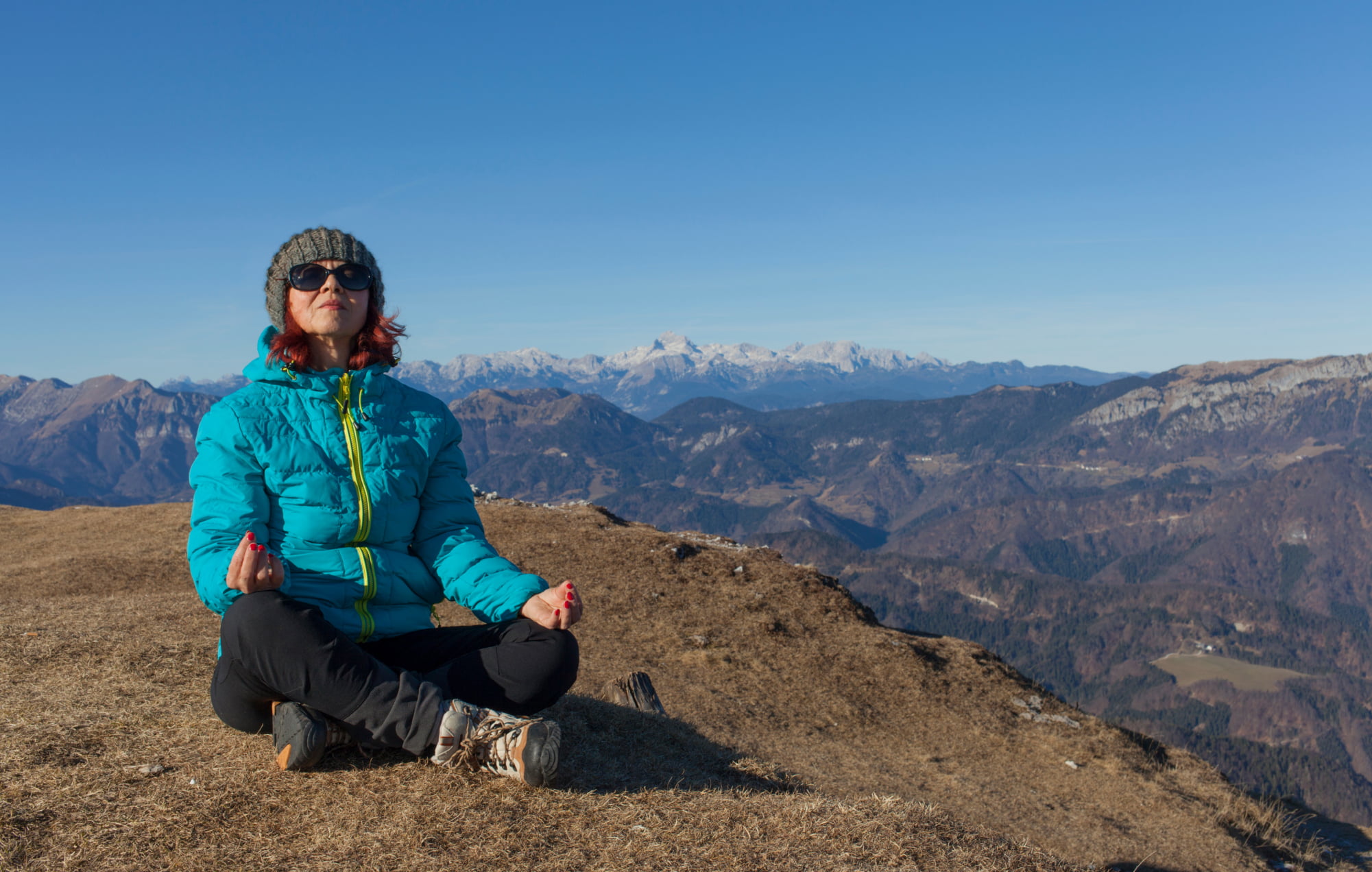 Woman breathing deeply in the mountains