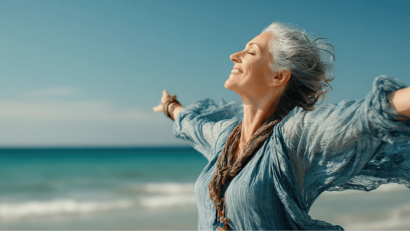 Woman smiling facing the sea and the sun