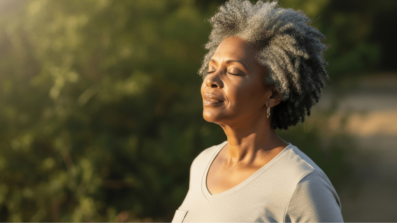 Old woman breathing deeply facing the sun