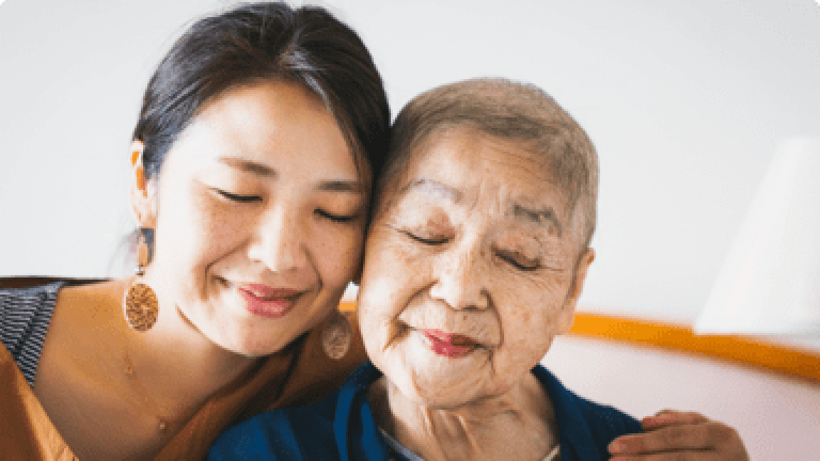 elder woman hugging a young woman