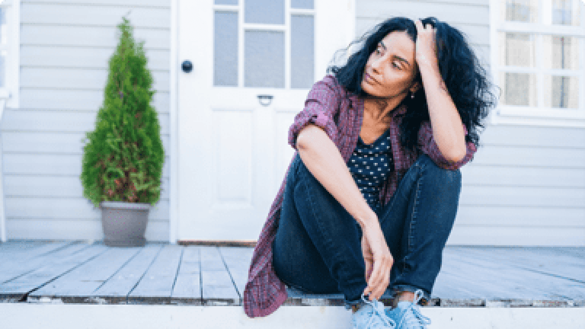 elder woman sitting on the porch