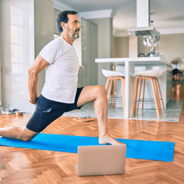 man middle age doing indoor yoga