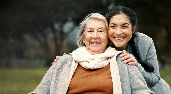 young woman holding an elder woman