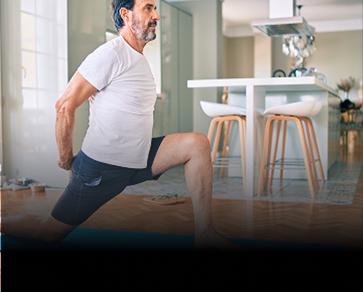 man middle age doing indoor yoga