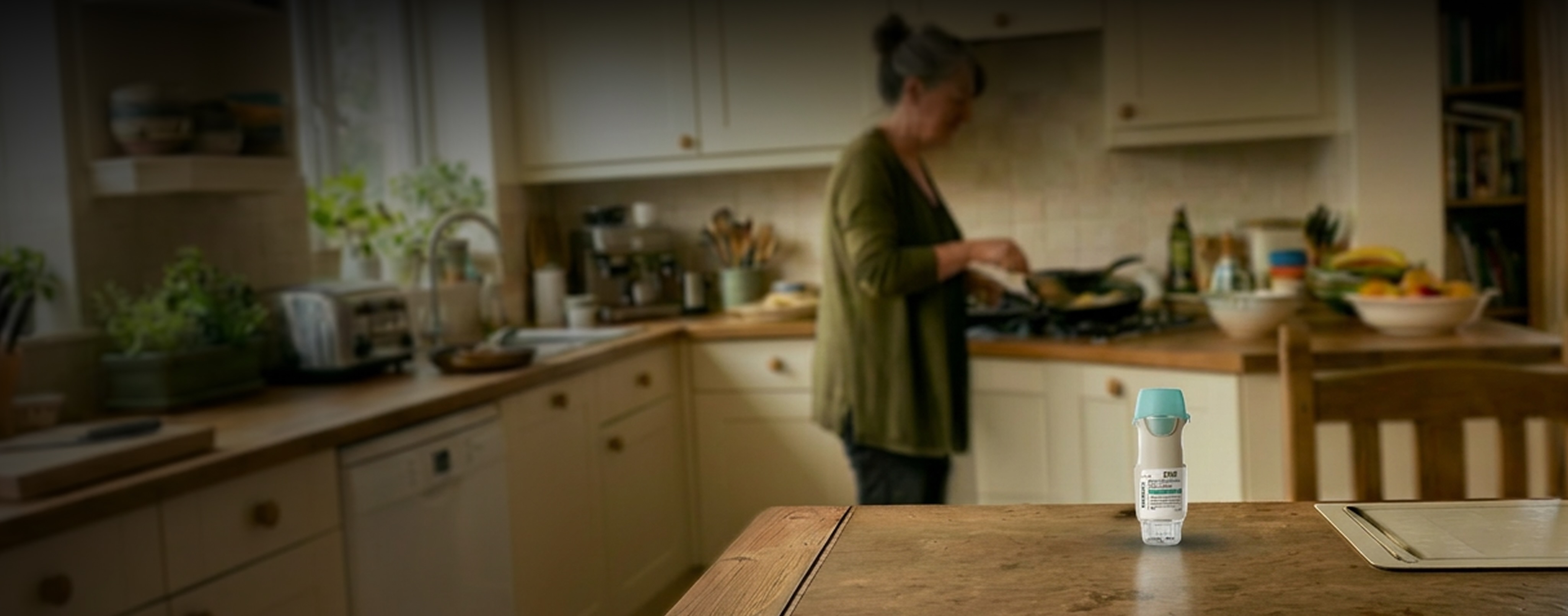 woman cooking with the spiriva inhaler on the kitchen table