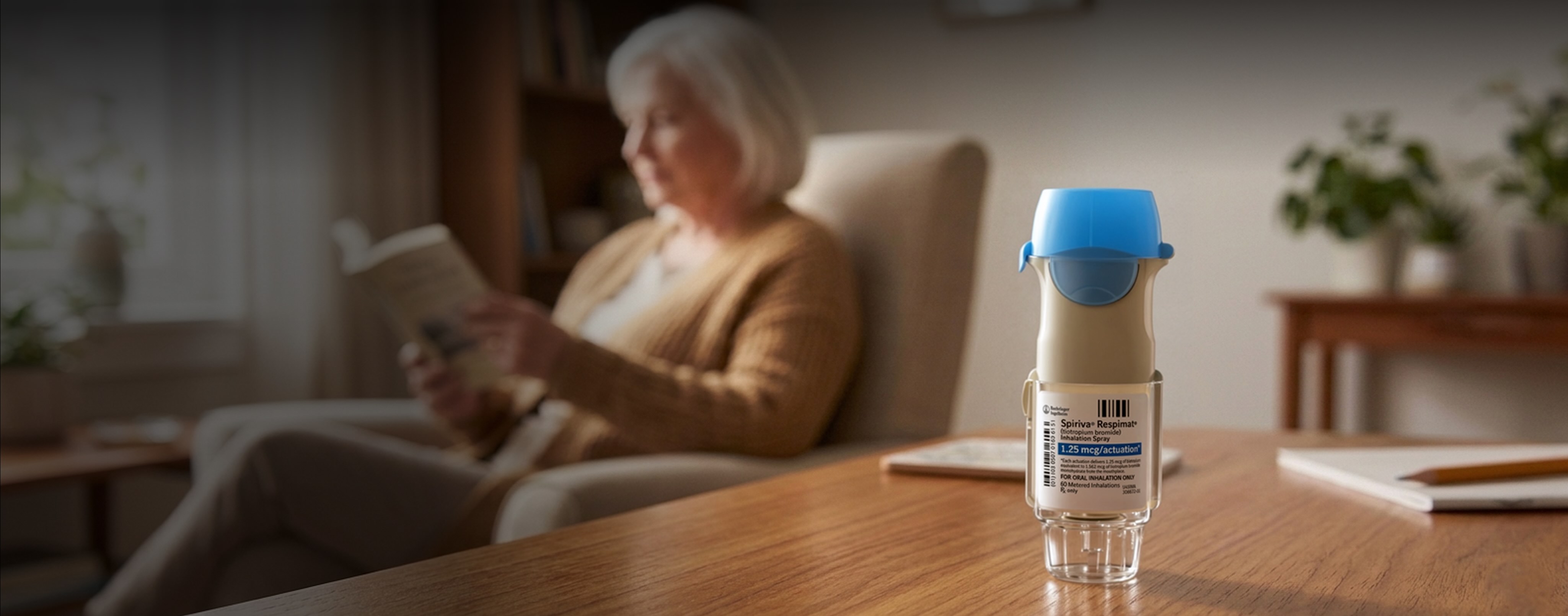Spiriva Respimat 1.25mcg inhaler on wooden table with woman reading in blurred background