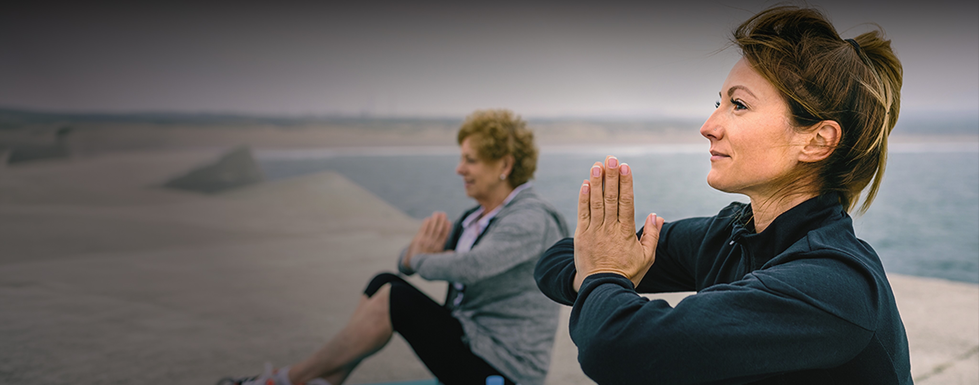 two ladies doing yoga